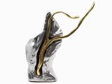 a close up of a silver and gold sculpture on a white background