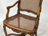 an old wooden chair with wicker seat on a white background