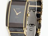 an image of a black and gold watch on a white background