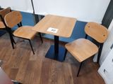 three chairs and a table in the corner of a room