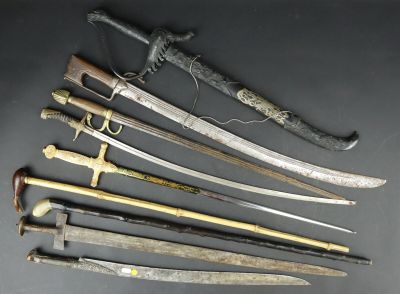 several different types of swords are displayed on a black surface