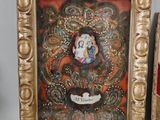 a picture of a painting on the wall next to a pair of scissors