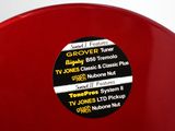 a close up of a red vase with a label on it
