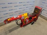 a close up of a red and yellow machine on a cement floor