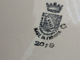 a close up of a plate with a crown on it
