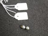 two tags and two pearls on the ground