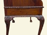 a wooden piano that is sitting on top of a table
