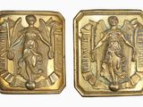 two gold medals depicting the virgin and child of jesus