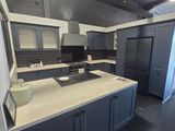 a kitchen with a sink, stove, and refrigerator in it