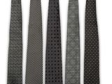 four ties are lined up in a row on a white surface