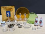 a lot of glass items on a table with a picture frame