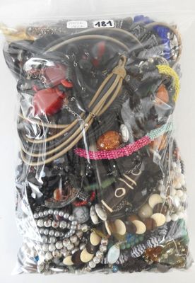 a bag of assorted jewelry on a white surface