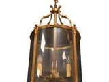 a gold and black light fixture hanging from the ceiling