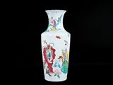 a white vase with a painting on it on a black background