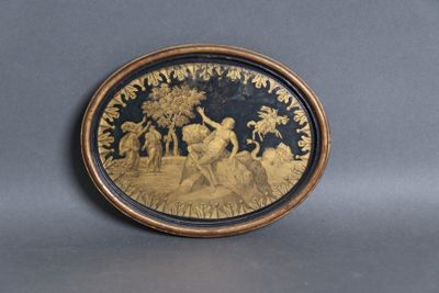 a gold plate with a picture of a man and a woman on it