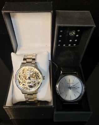 two watches that are sitting in a box