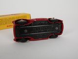 a red and black toy car next to a yellow box