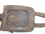 an old rusted metal object on a white surface