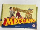 a book with a picture of two children playing with a model of a crane