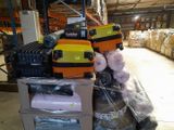 a pile of luggage sitting on top of a cart in a warehouse