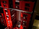 many red boxes stacked on top of each other in a room