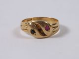 a close up of a gold ring on a white surface