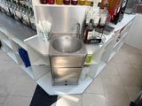 a stainless steel sink in the corner of a counter
