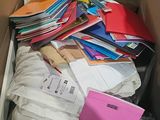 a cardboard box full of files and folders in it