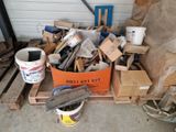 a pile of wood and a bucket of paint on a pallet