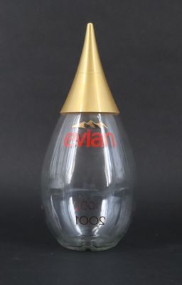 a clear glass bottle with a gold top and a gold cap