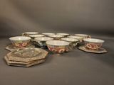 several cups and saucers are lined up on a table