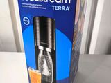 a soda streamer in the box on the table