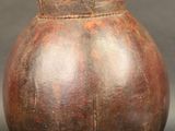 un vase marron muni d'un couvercle, posé sur une table