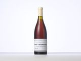 the bottle of wine is sitting on a table with a white background
