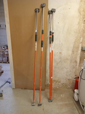 two poles that are standing in the corner of a room