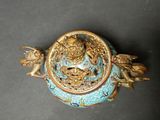 a blue and gold vase with a dragon on it