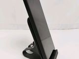 a cell phone that is on a stand on the table