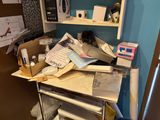 a pile of papers sitting on top of a metal cart