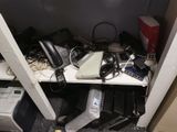 a desk with a lot of electronics on top of it