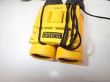 a pair of yellow binoculars sitting on a table