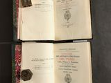 three open books on a table with a black background