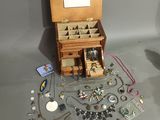 a small wooden box with many different items in it