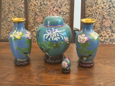 three vases sitting on a table next to each other