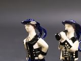 two figurines of a man and a woman dressed in black and white