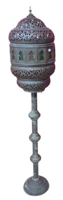 a metal lamp that is on top of a stand