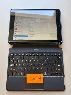 a laptop and a tablet on a table with a sticky note on it