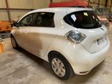 a picture of a small white car parked in a garage