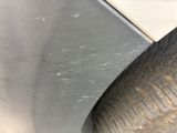 a close up of a car tire with scratches on it