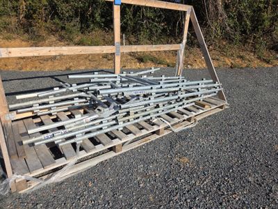 a wooden pallet that has a bunch of metal bars on it
