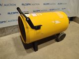 a yellow barrel sitting on top of a cement floor next to a sign